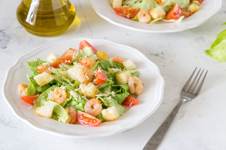 Caesar salad with shrimps on a white background.の写真素材