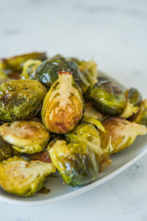 Cooked Brussels sprouts in a white plate.の写真素材