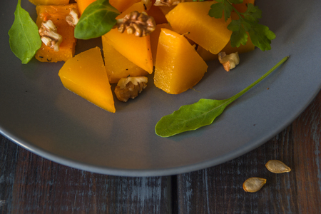 Salad with pumpkin, walnuts and green leaves.の写真素材