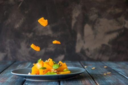 Salad with pumpkin, walnuts and green leaves, levitation ingredients.の写真素材