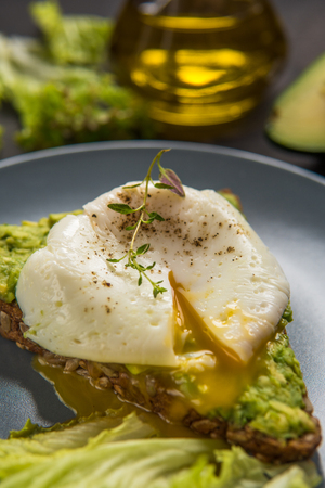 Sandwich with avocado and poached egg. Healthy breakfast.の写真素材