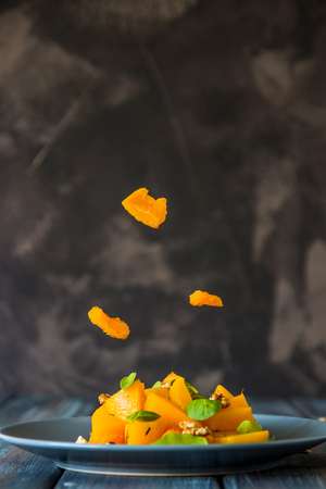 Salad with pumpkin, walnuts and green leaves, levitation ingredients.の写真素材