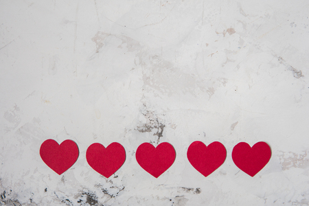 Red paper hearts on a white texture background, copy space.の写真素材