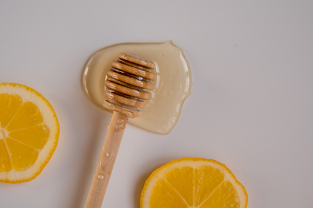 Honey stick and two lemon slices top view.の写真素材