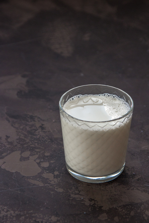 Milk in a glass beaker on a dark background.の写真素材