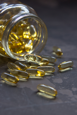 Yellow vitamin capsules, soft gelatin capsule with oily drug.の写真素材