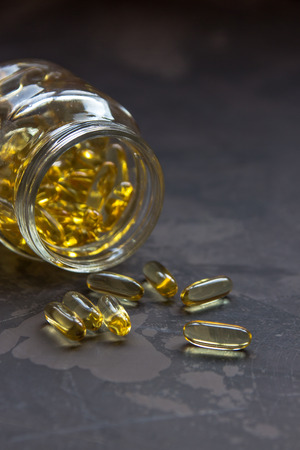 Yellow vitamin capsules, soft gelatin capsule with oily drug.の写真素材