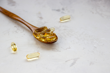 Yellow vitamin capsules, soft gelatin capsule with oily drug and nutritional supplement.の写真素材