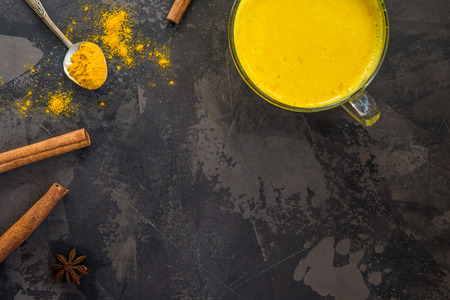 Golden turmeric milk with cinnamon. Healthy and aromatic detox beverage.の写真素材