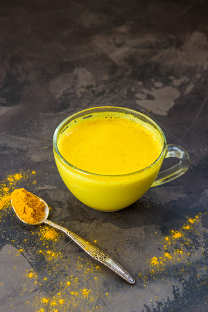 Golden turmeric milk. Healthy and aromatic detox beverage.の写真素材