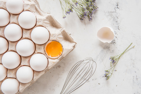 White eggs in a box on a light background.の写真素材