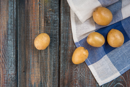 Baby potatoes on a table. Raw potatoes.の写真素材