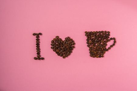 I love coffee. Coffee beans text on a pink background.の写真素材