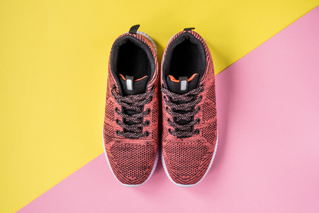 Sneakers on a yellow and pink background top view.の写真素材