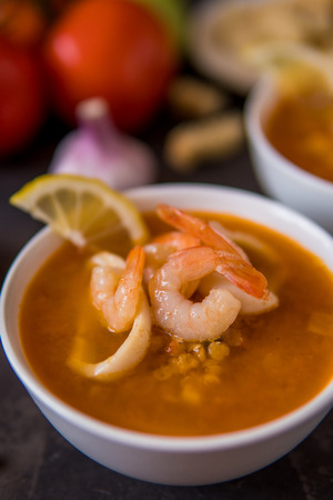 Lentil soup with seafood. Red soup with shrimps and squid, copy space.の写真素材