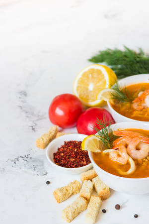 Lentil soup with seafood. Red soup with shrimps and squid.の写真素材