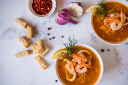 Lentil soup with seafood. Red soup with shrimps and squid top view.の写真素材