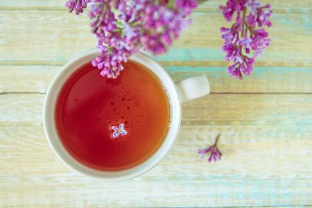 Cup of tea and blooming lilac, petal in a teaの写真素材