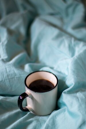 Coffee cup on a bed. Hygge style. Good morning,  still lifeの写真素材