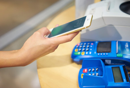 a woman paying with mobile phone