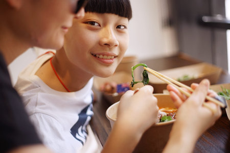Asian mother have lunch with son in a restaurant
