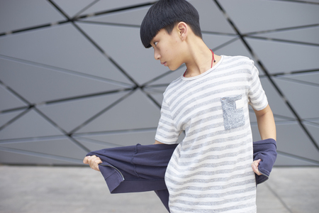 portrait of cool Asian kid dancing outdoorsの写真素材