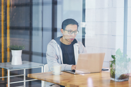 Portrait of Asian businessman working on laptop in officeの写真素材