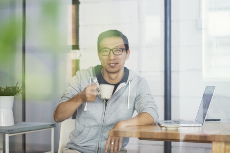 Portrait of Asian businessman smiling and looking at cameraの写真素材