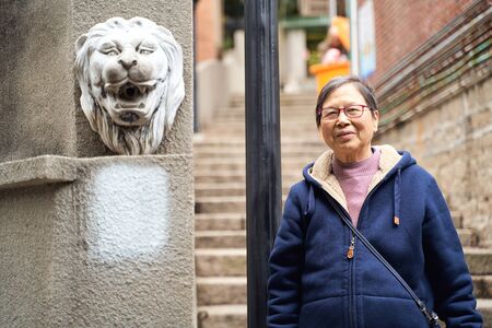 portrait of senior Asian woman traveling in old townの写真素材