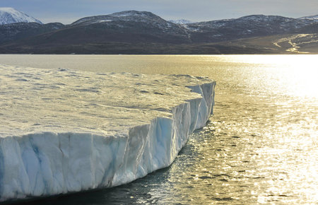 Global warming. Icebergs and mountains in the ocean.