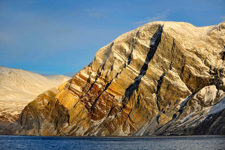 Global warming. Icebergs and mountains in the ocean.