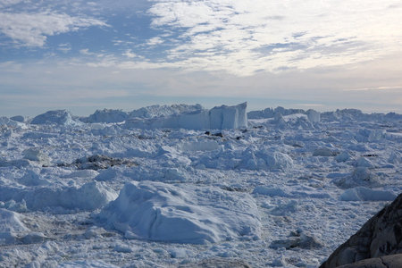 Greenland. Iceberg and ice from glacier in arctic nature. Icebergs in Ilulissat icefjord. Affected...