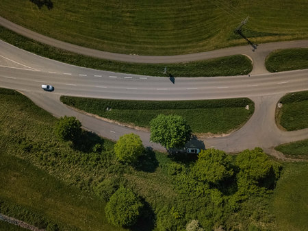The top view of a car at a country road made by a drone.