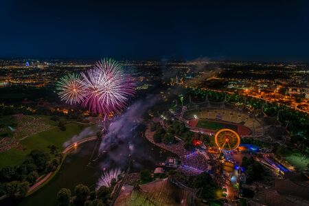 Aerial panoramic cityscape view with bright fireworks lights in night Munich.の写真素材