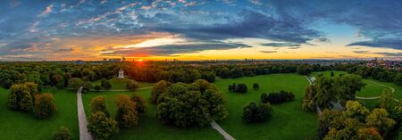 A beautiful start in the day. Sunset over Munichs English Garden as an aerial panorama.の写真素材