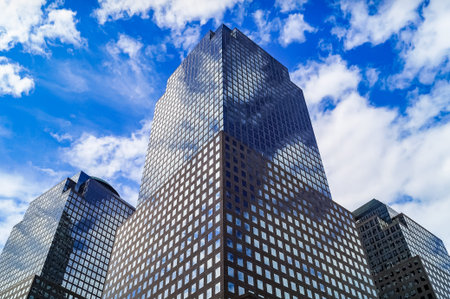 Office building close up with reflecting sky.