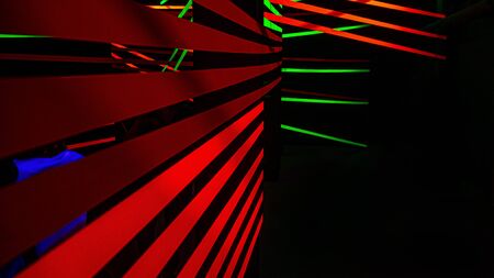 Neon colored bands in a dark room.の写真素材