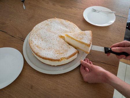 Cut of a creamy cheesecake, self baked by my wife.