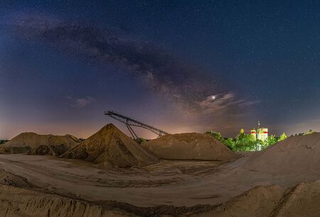 Conveyor bridge at night and the milky way, watching the stars at a construction area.の写真素材