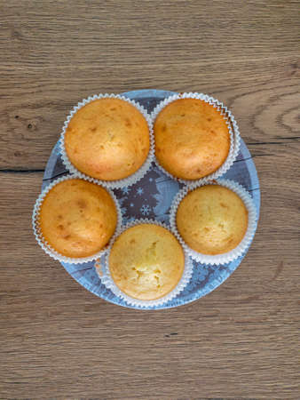 Plain cupcakes on a white plate on table. Top viewの写真素材