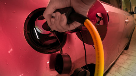 Red light at a recharge process of an electric car to symbolize the still existing problems with the electronic infrastructure and struggling difficulties, facing the e-mobility sector.の写真素材