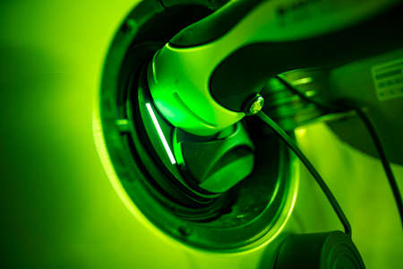 Green energy. Concept for recharge your car with renoeable energy at home per wallbox to fight environmental threats and try to heal the world.の写真素材