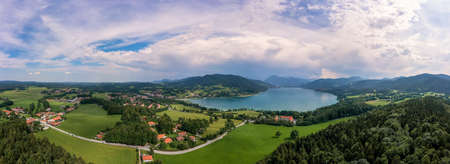 Bavarian recreation area of the Tegernsee, the view at the alps from a high angle view of a drone at a beautiful summer day with the Gut Kaltenbrunn in the foreground.の写真素材