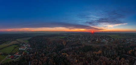 The sun is going down next the the beautiful monastery of Schaeftlarn in the fall season.の写真素材