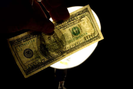 checking watermark 100 usd isolated on blackの写真素材