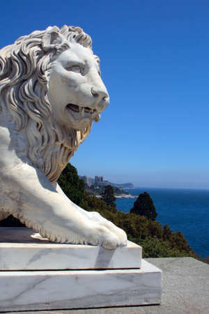 white lion statue looking at blue sea in Crimea Ukraineの写真素材