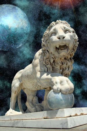 lion statue with blue planet in open cosmos spaceの写真素材
