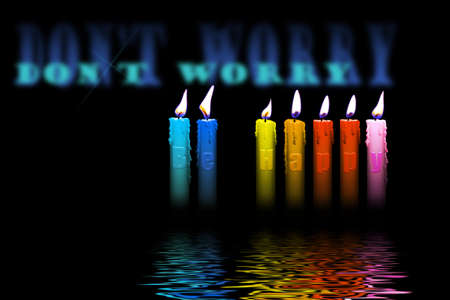 colored candles with dont worry be happy letters inside flooding in waterの写真素材