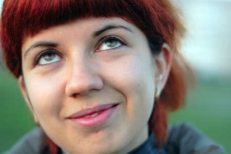 closeup portrait attractive young girl looking upwards and dreaming about somethingの写真素材