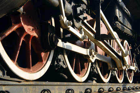 red wheels of old steam train with connecting rod